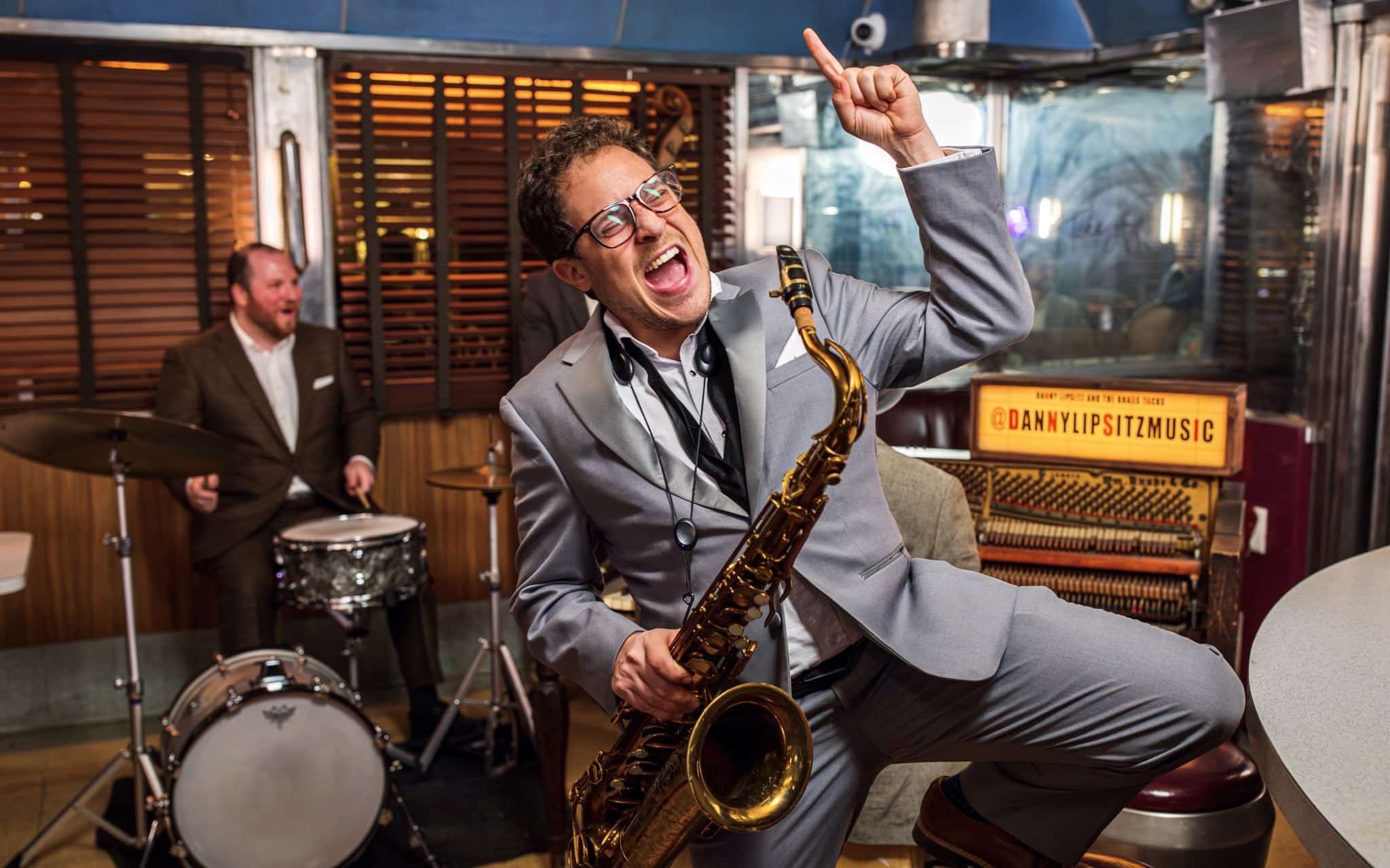 Danny Lipsitz with his sax in front of the band